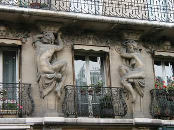 Carvings on a building on rue St. Dominique.