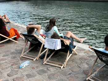 People in rented beach chairs, enjoying the Seine.